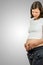 Pregnant woman cradling her belly in her hands