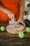 Pregnant woman cutting home-made apple pie