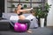 Pregnant woman is doing exercises with gymnastic ball