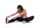 Pregnant woman doing floor exercises on white background