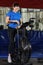 Pregnant woman doing intense workout at gym air bike