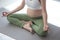 Pregnant woman doing yoga exercising on gray mat hand is lotus symbol in room. Pregnant woman yoga and healthy lifestyle concept.