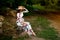 A pregnant woman in a dress walks in nature in the forest in summer