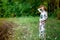 A pregnant woman in a dress walks in nature in the forest in summer