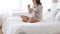 Pregnant woman eating croissant in bed at home 26