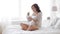 Pregnant woman eating salad in bed at home 24