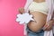 Pregnant woman with empty paper thought cloud on pink, closeup. Choosing baby name