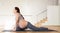 Pregnant woman is engaged in yoga. Half Pigeon Pose or Ardha Kapotasana