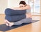 Pregnant woman is engaged in yoga. Seated Forward Fold or Paschimottanasana