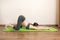 Pregnant woman exercising on green mat in room. Pregnancy Yoga and Fitness concept at coronavirus time