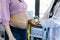Pregnant woman exposing her belly while doctor using a measuring tape to follow the growth of the baby at a hospital