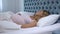 Pregnant woman feeling unwell lying in bed, sleep disorder, health problems