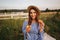 Pregnant woman in the field eating fresh backed crispy croissant. Healthy food. Young woman eats very appetizing