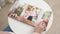 Pregnant woman flips through photo book from family pregnancy photo shoot. view top.