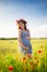 Pregnant woman in a flowering poppy field