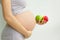 Pregnant woman with fruit in her hands. Vitamins for pregnant women. Vegetarianism. Useful products for pregnant women. Diet