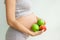 Pregnant woman with fruit in her hands. Vitamins for pregnant women. Vegetarianism. Useful products for pregnant women. Diet