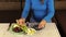 Pregnant woman girl hands put grape fruits in dish