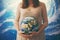 Pregnant woman with a globe in her hands. The concept of the miracle of life, the connection with the planet