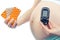 Pregnant woman with glucometer and medical pills, diabetes and health care during pregnancy