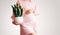 Pregnant woman with green plant in hands. Concept of pregnancy, fertility and health care of women, maternity leave