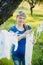 Pregnant woman hanging baby clothes in linen rope