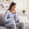 Pregnant Woman Having Pregnancy Morning Sickness Sitting On Couch