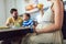 Pregnant woman and her family breakfasting in the kitchen