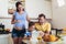 Pregnant woman and her family breakfasting in the kitchen