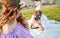 Pregnant woman and her husband rseting in park at evening