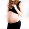 Pregnant woman holding a big dark chocolate bar. Gestational diabetes concept