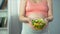 Pregnant woman holding bowl of vegetable salad rich in vitamins and nutrients