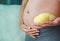 Pregnant woman holding durian at her belly. Dieting Concept