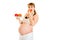 Pregnant woman holding fruits and eating apple