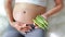 Pregnant woman holding green roselle at her belly. Dieting Concept. Healthy Lifestyle