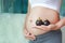 Pregnant woman holding mangosteens at her belly. Dieting Concept