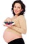 Pregnant woman holding small sneakers