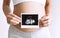 Pregnant woman holding ultrasound baby image