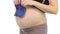 Pregnant woman holds blue baby booties up to her belly waiting for baby, white, closeup