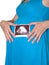 The pregnant woman holds a picture of ultrasonography of the child on a white background