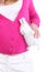 Pregnant woman holds white toy rabbit isolated