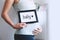 Pregnant woman holds whiteboard with text message - BABY!