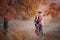 Pregnant woman with husband in the autumn forest. Mother and father. Happy parents. Autumn family portrait. Pregnancy, maternity,