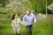 pregnant woman with husband  in blooming garden