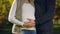 Pregnant woman with husband stroking belly, prenatal care, fertility science