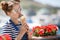 Pregnant woman with ice cream cone near the ocean