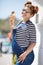 Pregnant woman with ice cream cone near the ocean