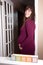 Pregnant woman leaning on doorframe