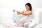 Pregnant woman looking at baby\'s clothes