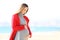 Pregnant woman looking her belly on the beach